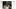 Hightouch Ad Studio UI editing a 'Spring Campaign' luggage ad with the headline 'One is simply not enough — Meet the new collection,' a sidebar of size variant thumbnails, and a brief panel detailing message and hook strategy.