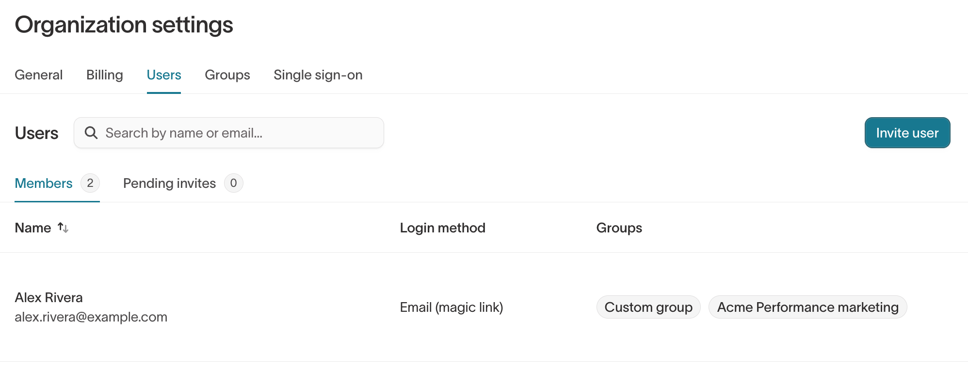 The Users page in Organization settings, showing the Members and Pending invites tabs with each member's login method and groups